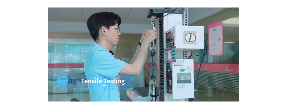 The image shows a fabric tensile strength test.